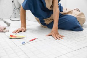 older woman laying on her bathroom floor